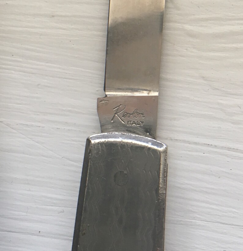 Set of 3 knives Sabre Revlon Pocket Knives and one that is not Marked