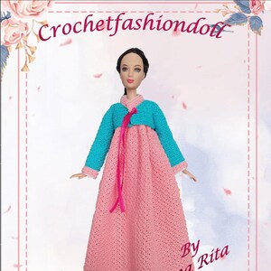 May include: A doll wearing a handmade, crocheted Korean dress. The dress is primarily pink with a turquoise bolero-style top and pink trim. The text "Crochetfashiondoll" and "Ae-Shin Korean dress" are visible.
