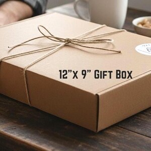A rectangular brown gift box, 12 inches by 9 inches, tied with twine.