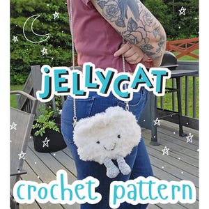 May include: A fluffy, white cloud-shaped crochet bag with a smiling face and grey legs, worn with a silver chain strap. The words "JELLYCAT" and "crochet pattern" are written in turquoise. The bag is worn over blue jeans.