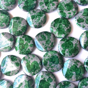 May include: A collection of round, green and silver speckled beads. The beads have a metallic finish and are perfect for jewelry making.