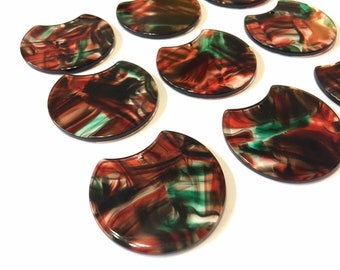 May include: A set of ten half-circle shaped resin cabochons with a marbled pattern in shades of red, green, and black.
