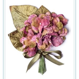 May include: A bouquet of pink velvet flowers with green velvet leaves tied with a green ribbon.