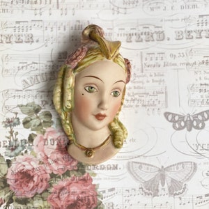 Edwardian style handpainted Porcelain doll heads for use in mixed media, craft and vintage projects. Exquisite hand painted doll faces.