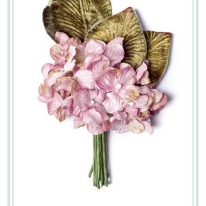 May include: A bouquet of mauve hydrangea flowers with green velvet leaves. The flowers are arranged in a cluster and the leaves are behind the flowers. The bouquet is on a white background.  HYDRANGEA POSY MAUVE