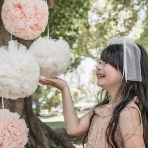 large pom pom balls. tulle pom poms. childrens room decor . wedding decor . tulle hanging pom poms . Nursery decor