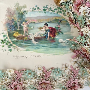 May include: A spool of delicate lace trim with pink, green, and white floral designs. The lace has a glittery finish and is perfect for adding a touch of elegance to any project.