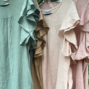 May include: Four linen tops with ruffled sleeves in shades of green, brown, pink, and light pink.