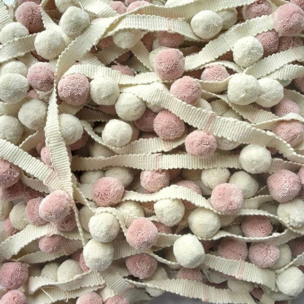 Pom Pom trimming . Peaches and cream pompom trim for household wares , cushion trims , for blinds , curtains , clothing , accessories .