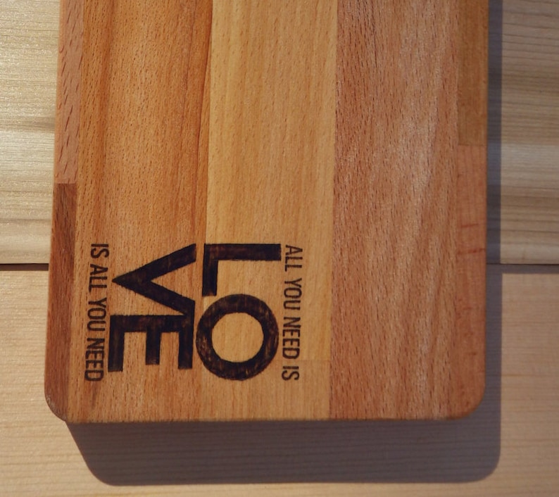 All you need is love Solid Beech Cutting Board with Woodburning Illustration of Classic Saying love is all you need