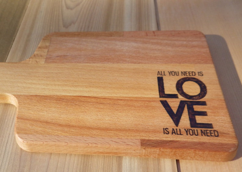 All you need is love Solid Beech Cutting Board with Woodburning Illustration of Classic Saying love is all you need