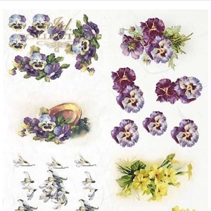May include: A sheet of rice paper with various floral designs. The sheet features purple pansies, yellow primroses, and white snowdrops. The paper is 21.5 x 29.7 cm and is part of the "I'd Collection".