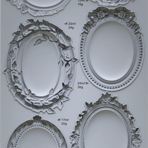 May include: Five different sized oval-shaped silicone molds for making resin brooches. The molds are made of clear silicone and have intricate designs around the edges. The molds are labeled with the size in milliliters and grams. The text "VINTAGE BROOCHES IOD" is printed at the bottom of the image.