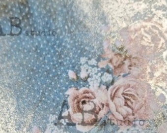 May include: A close-up of a blue and gold fabric with a floral pattern. The fabric has a subtle shimmer and a delicate texture. The flowers are pink and white and have a vintage feel. The text "AB Studio" is visible in the lower left corner of the image.