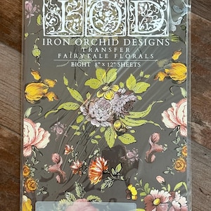 May include: A package of Iron Orchid Designs transfer sheets featuring a floral pattern with a dark gray background. The package says "Fairy Tale Florals" and "Eight 8" x 12" sheets".