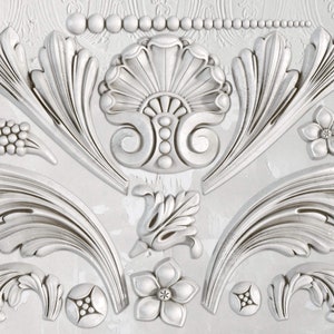 May include: A set of 12 white, decorative, plaster moldings with intricate floral and scroll designs. The moldings are perfect for adding a touch of elegance to any home decor project.