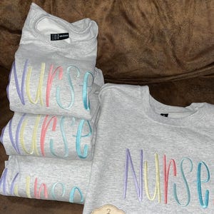 Embroidered nurse crewneck pastel colors