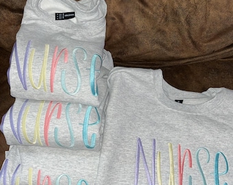 Embroidered nurse crewneck pastel colors