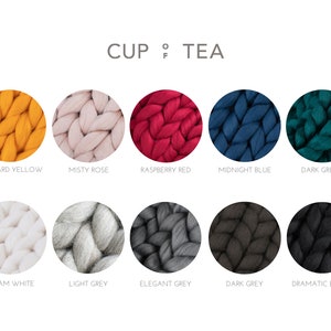 May include: Ten color swatches of yarn in various shades of yellow, pink, red, blue, green, white, gray, and black. The yarn is chunky and has a textured appearance. The colors are labeled with their names: Mustard Yellow, Misty Rose, Raspberry Red, Midnight Blue, Dark Green, Cream White, Light Grey, Elegant Grey, Dark Grey, and Dramatic Black.