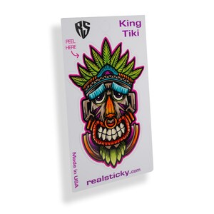 May include: A sticker featuring a colorful cartoon tiki head with a green headdress and the text "King Tiki" and "realsticky.com".