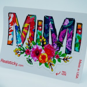 May include: A colorful floral sticker with the word "MIMI" in a bold, black outline. The sticker has a peel-and-stick backing and is made in the USA. The text "Realsticky.com" is printed in the bottom left corner.