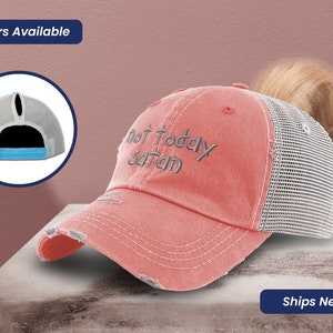 May include: A pink and gray distressed baseball cap with a ponytail hole in the back. The front of the cap has the text "Not Today Satan" embroidered in gray.