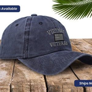 May include: A dark blue baseball cap with an embroidered American flag and the text "Vietnam Veteran".