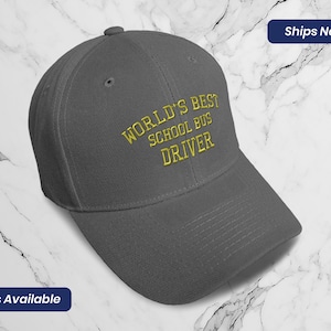 May include: Gray baseball cap with yellow embroidered text that reads "World's Best School Bus Driver".