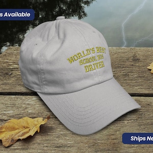 May include: A gray baseball cap with the text "WORLD'S BEST SCHOOL BUS DRIVER" embroidered in yellow.