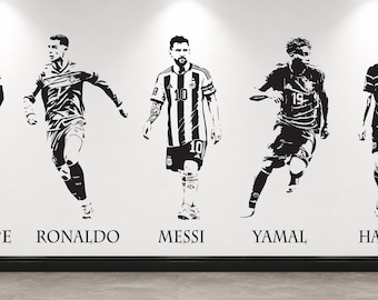 May include: A black and white wall decal featuring five soccer players in action poses. The figures are labeled with the names MBAPPE, RONALDO, MESSI, YAMAL, and HAALAND printed in a serif font below each respective player illustration.