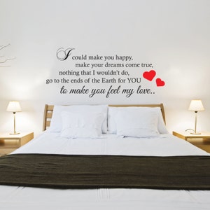 May include: A white wall with a black and white quote that reads "I could make you happy, make your dreams come true, nothing that I wouldn't do, go to the ends of the Earth for YOU to make you feel my love." There are two red hearts on the right side of the quote.