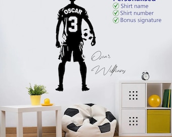May include: A black wall decal of a soccer player seen from behind, wearing a jersey with the name OSCAR and the number 3. The player holds a soccer ball. Text to the right reads Personalised, Shirt name, Shirt number, Bonus signature, and Oscar Williamy.