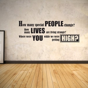 May include: A wall with a quote written on it in black lettering. The quote reads: "How many special PEOPLE change? How many LIVES are living strange? Where were YOU while we were getting HIGH?"