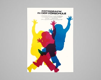 May include: A poster featuring the text "FOTOGRAFIK IN DER VORSCHULE" and colourful overlapping silhouettes of people. The silhouettes are yellow, magenta, and blue. Additional text is at the bottom.
