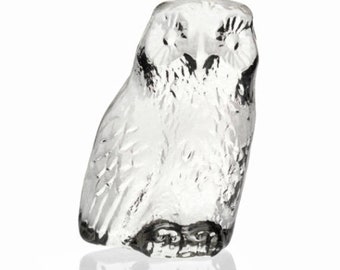May include: A clear glass owl figurine with black detailing on the eyes and feet. The owl is upright, with a textured surface. The figurine is a decorative item, suitable for home decor.