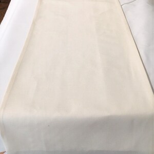May include: A plain white fabric tablecloth, perfect for a variety of occasions.