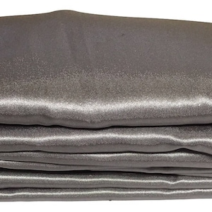 May include: A stack of smooth, silver satin fabric. The fabric is folded neatly and has a soft, luxurious sheen.