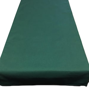 May include: A solid green table runner. The runner is made of a smooth, wrinkle-free fabric.