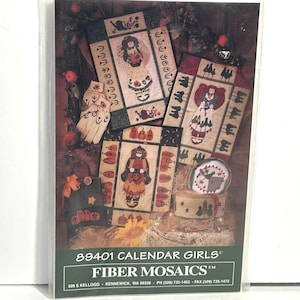 May include: A package featuring Fiber Mosaics' "Calendar Girls" designs. The image showcases several completed mosaic projects with Halloween themes, including figures, pumpkins, and decorative elements. The package includes the company's address and contact information.