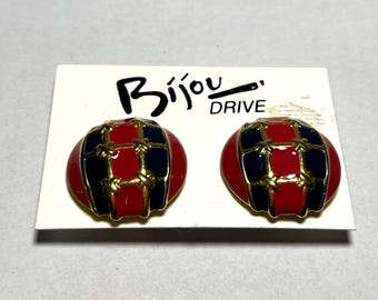 May include: A pair of gold tone clip-on earrings with red and blue enamel and a gold wire design. The earrings are on a white card with the text "Bijou Drive".