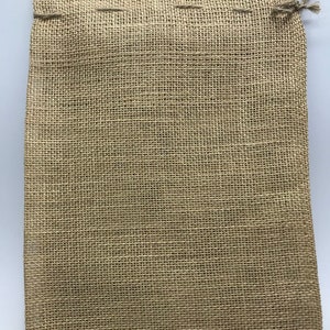May include: A brown burlap drawstring bag with a woven texture. The bag is empty and ready to be filled.