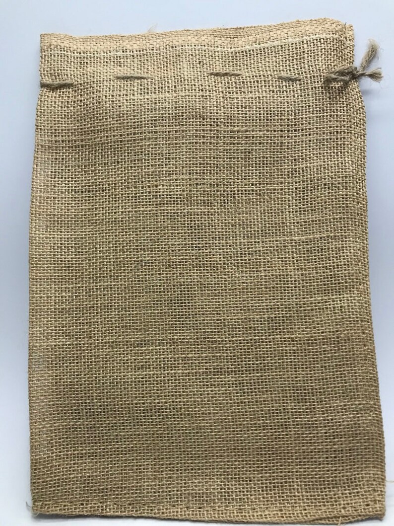 May include: A brown burlap drawstring bag with a woven texture. The bag is empty and ready to be filled.