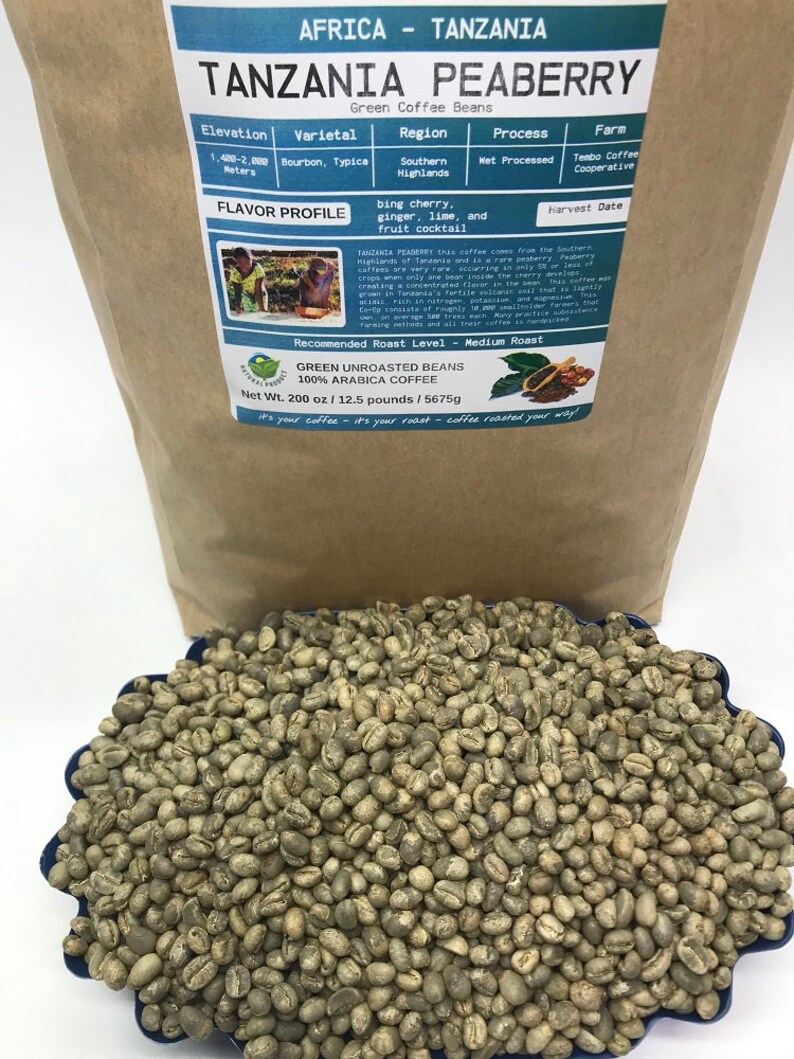 May include: A brown paper bag with a label that reads "Tanzania Peaberry Green Coffee Beans". The label includes information about the coffee's origin, variety, processing method, and flavor profile. The bag contains green coffee beans.