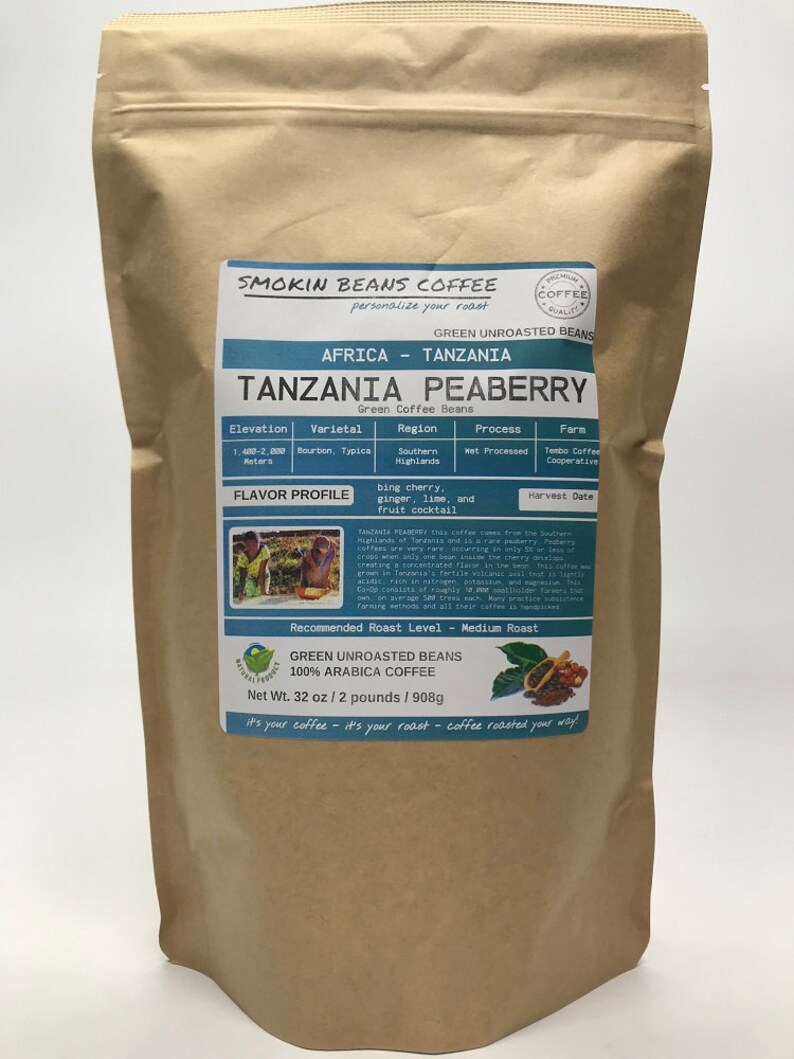 May include: A brown paper bag with a label that reads "Smokin Beans Coffee" and "Tanzania Peaberry Green Coffee Beans". The label also includes information about the coffee's origin, variety, region, process, farm, flavor profile, and recommended roast level. The bag contains 32 ounces of green unroasted coffee beans.