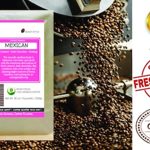 May include: A bag of Mexican coffee beans with a pink label that reads "Mexican" and lists the flavor notes as "Caramel - Dark Chocolate - Nutmeg". The label also includes information about the origin of the beans, the roast style, and the net weight. The bag is sitting on a pile of coffee beans.