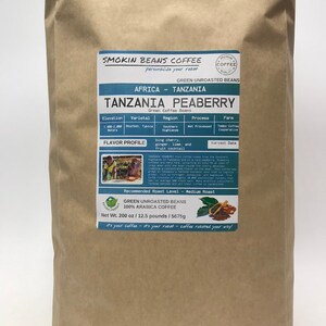 May include: A brown paper bag with a label for Tanzania Peaberry green unroasted coffee beans. The label includes information about the coffee's origin, variety, region, process, farm, flavor profile, and recommended roast level. The bag weighs 12.5 pounds or 200 ounces.