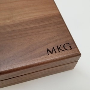 Walnut keepsake box, a large wooden box measuring 8x10 outside, 7x9 inside.  Shown with three letter monogram on the lower right corner of the lid.   Box is a beautiful brown in color with clear finish, and has a black velvet lining.