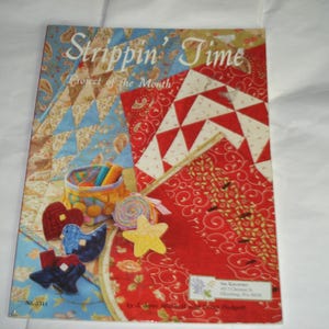 May include: A magazine titled "Strippin' Time Project of the Month" with a colorful patchwork design on the cover. The cover features a variety of fabric swatches, a basket of sewing supplies, and several fabric cutouts.