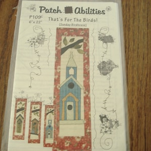 May include: A quilting pattern for a birdhouse, titled "That's For The Birds!" with a blue and yellow birdhouse design. The pattern is 6 inches by 22 inches and is called "Sunday Birdhouse".