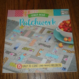 May include: A book titled "Lunch-Hour Patchwork" with a colorful patchwork quilt on the cover. The book features 15 easy-to-start quilting projects.